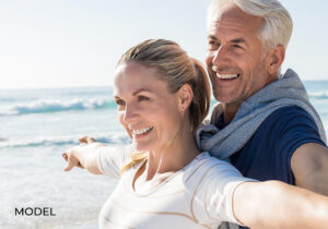 Couple Smiling and Embracing at Beach